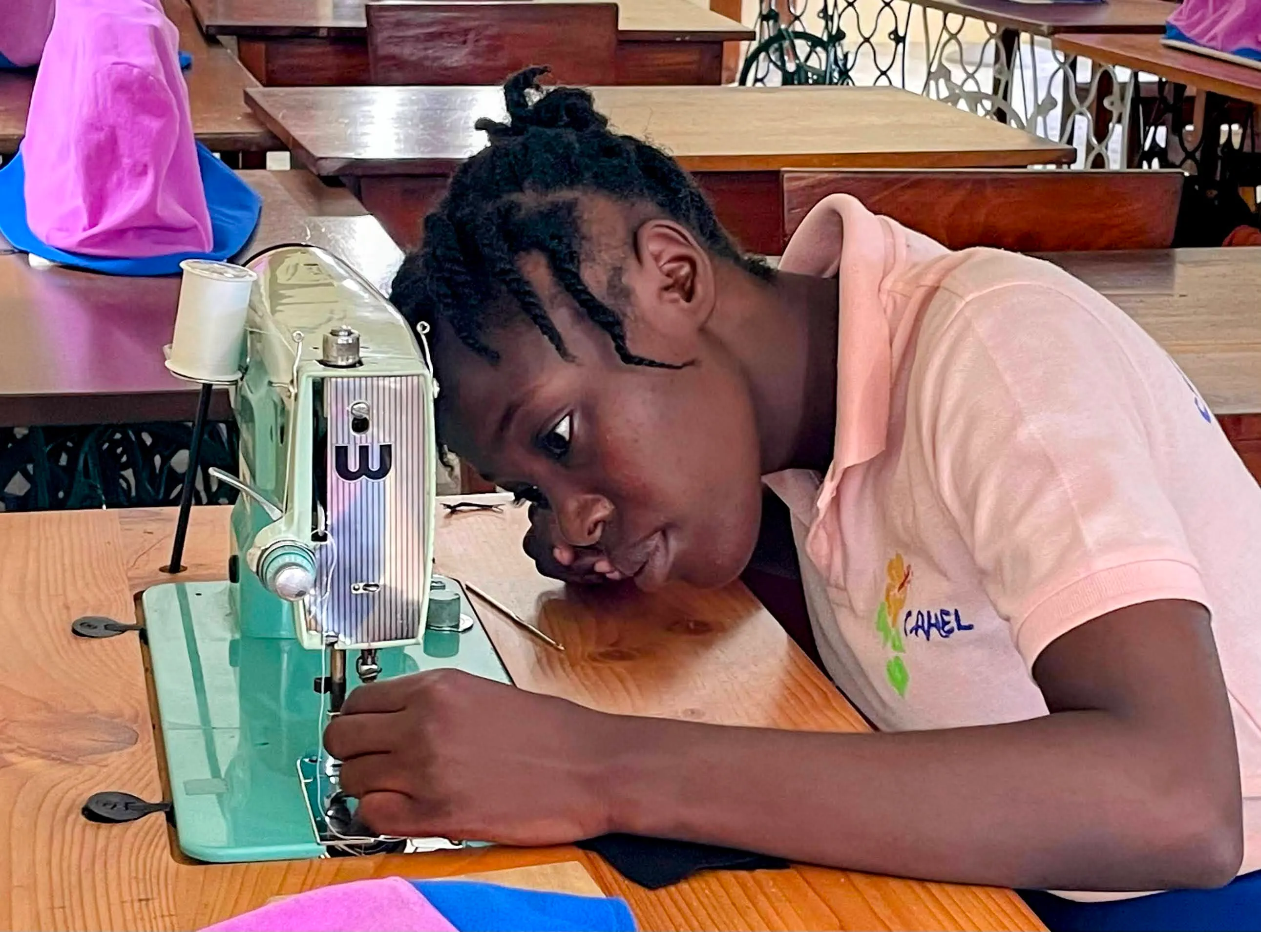 Students learning professional sewing and needlework skills at Centre Lumière